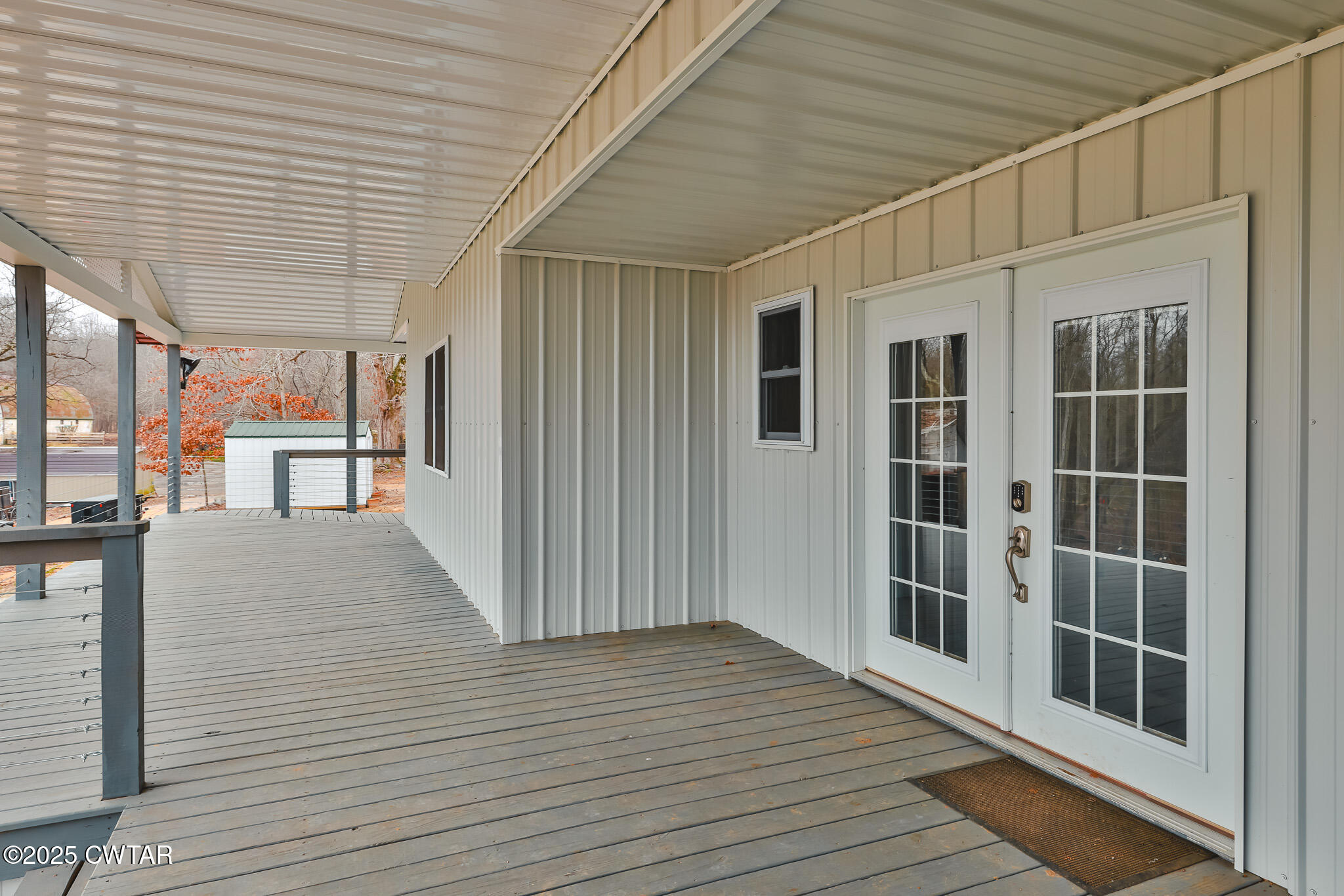 1421 Copper Spring Road Springville, TN 38256 - Photo 11 of 79 an empty room with wooden floor and windows