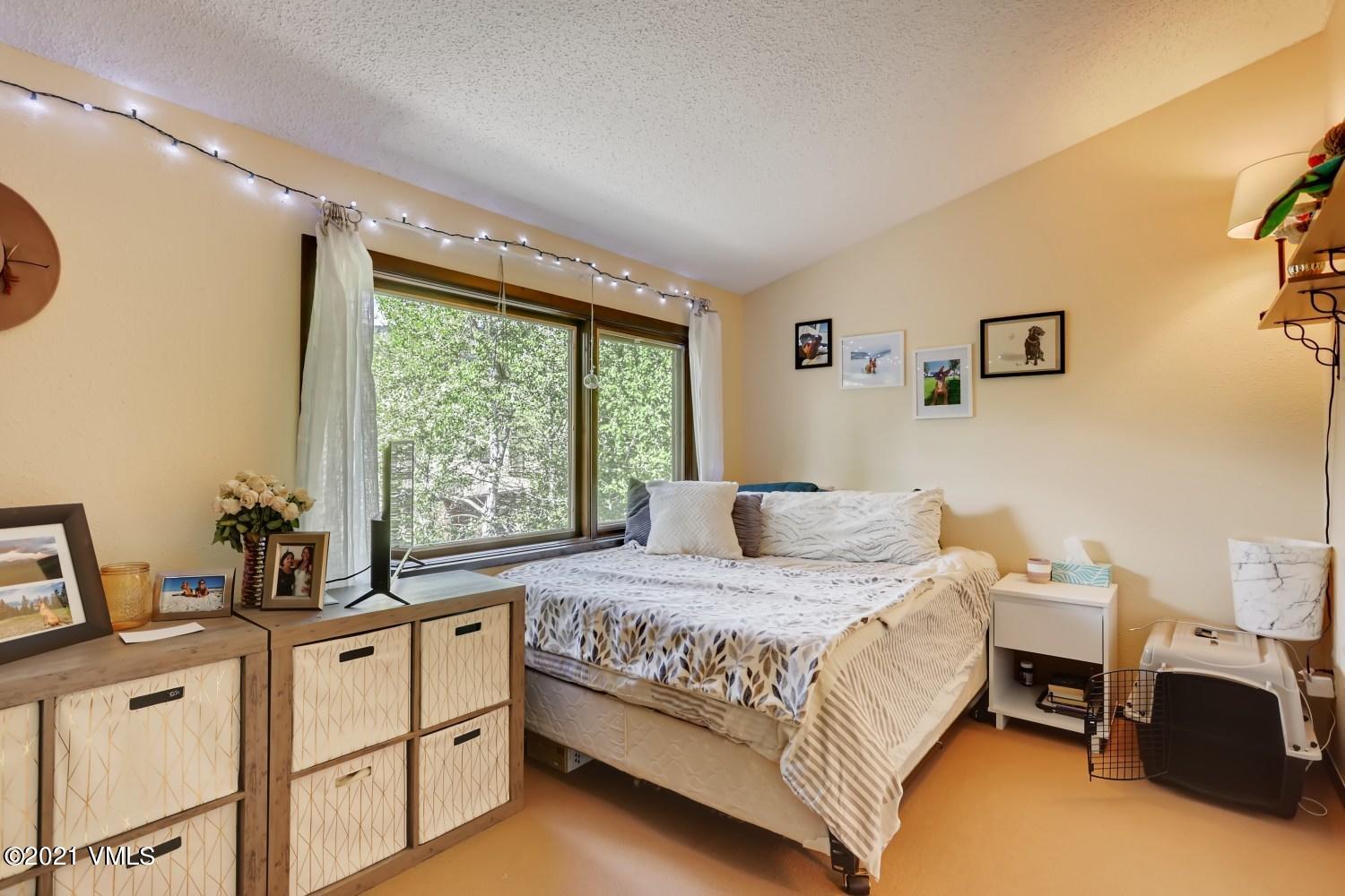 225 Gopher Road, Unit H50 Avon, CO 81620 - Photo 11 of 28 a bedroom with a bed and a window