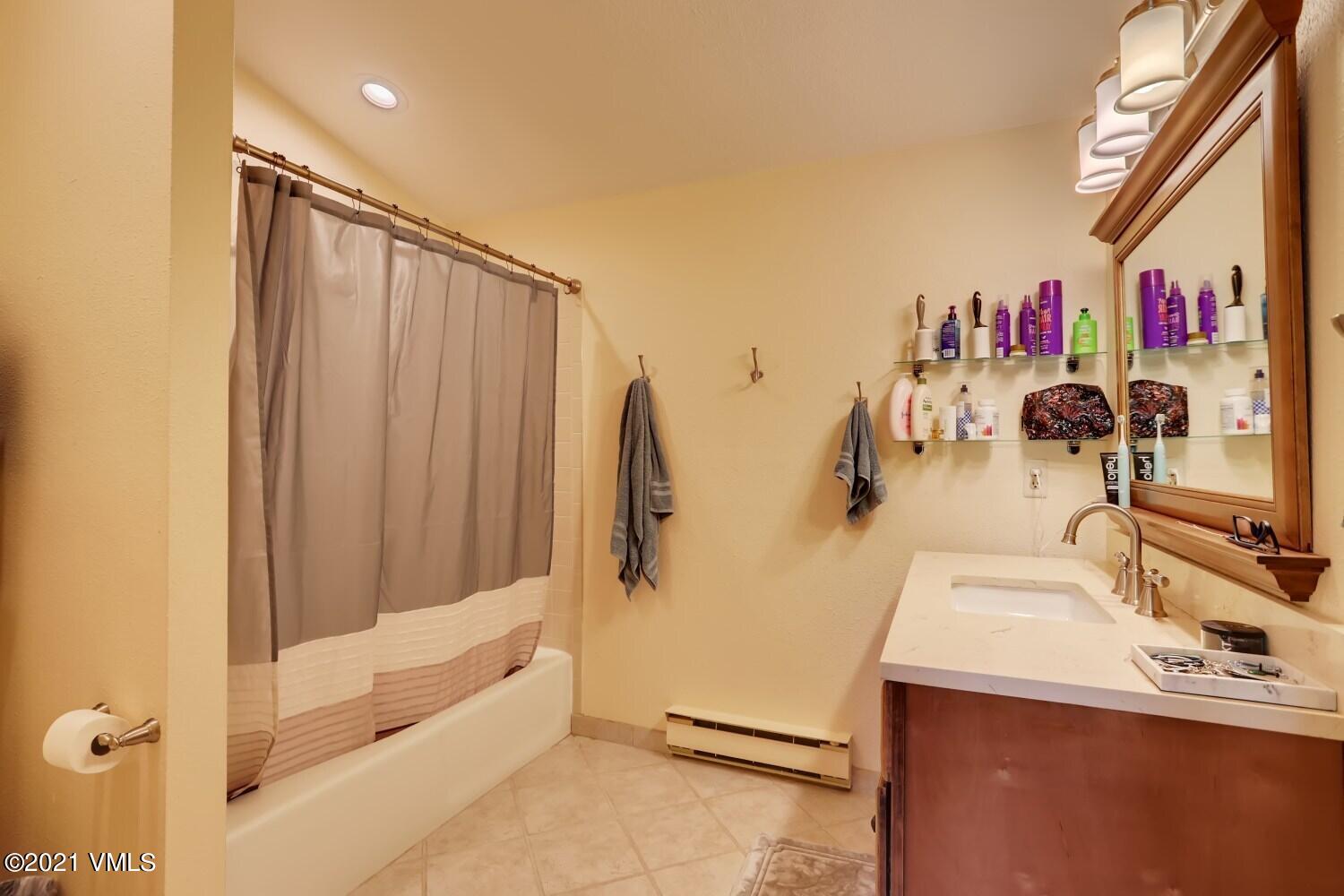 225 Gopher Road, Unit H50 Avon, CO 81620 - Photo 14 of 28 a bathroom with a sink and mirror