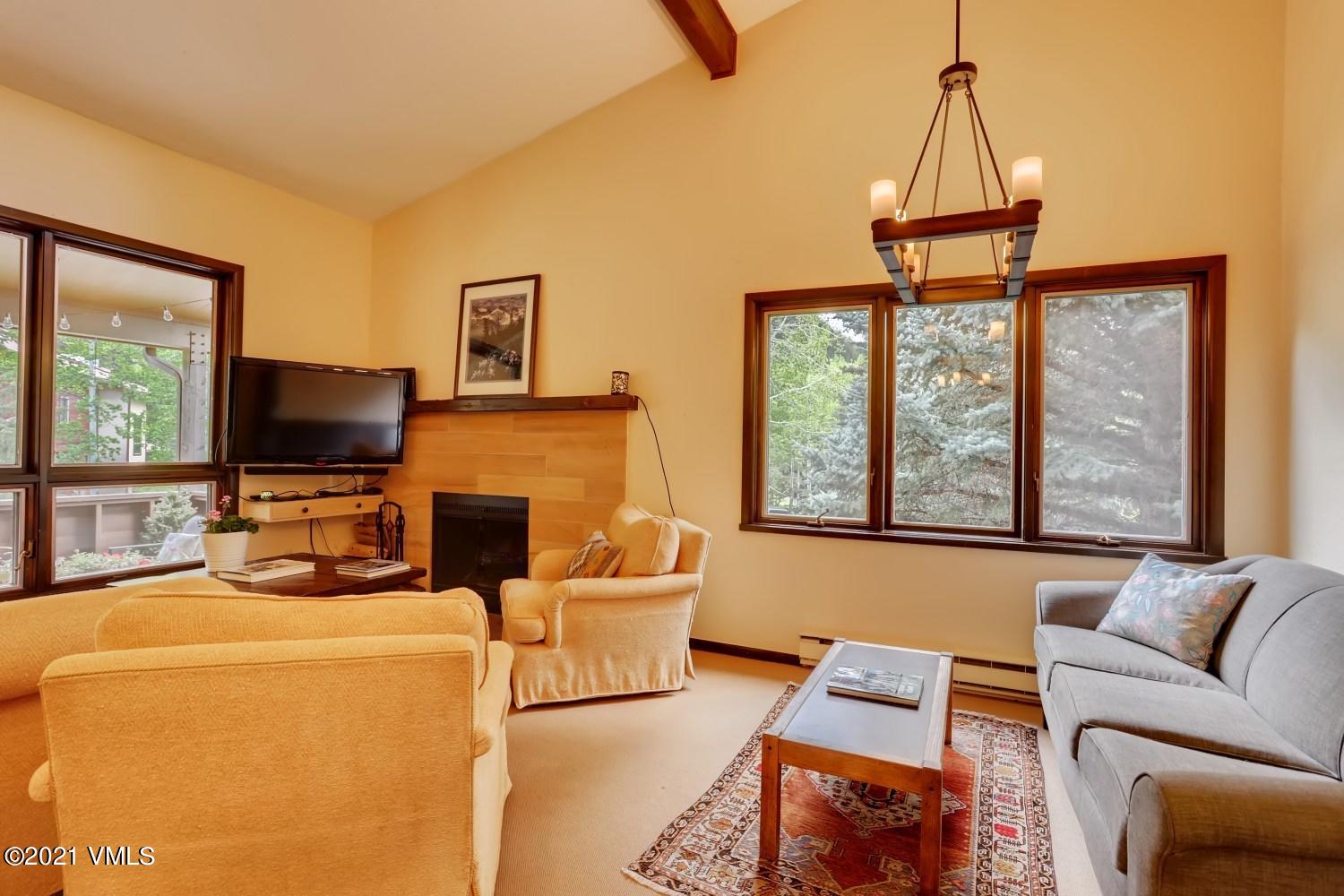 225 Gopher Road, Unit H50 Avon, CO 81620 - Photo 3 of 28 a living room with furniture a fireplace and a flat screen tv