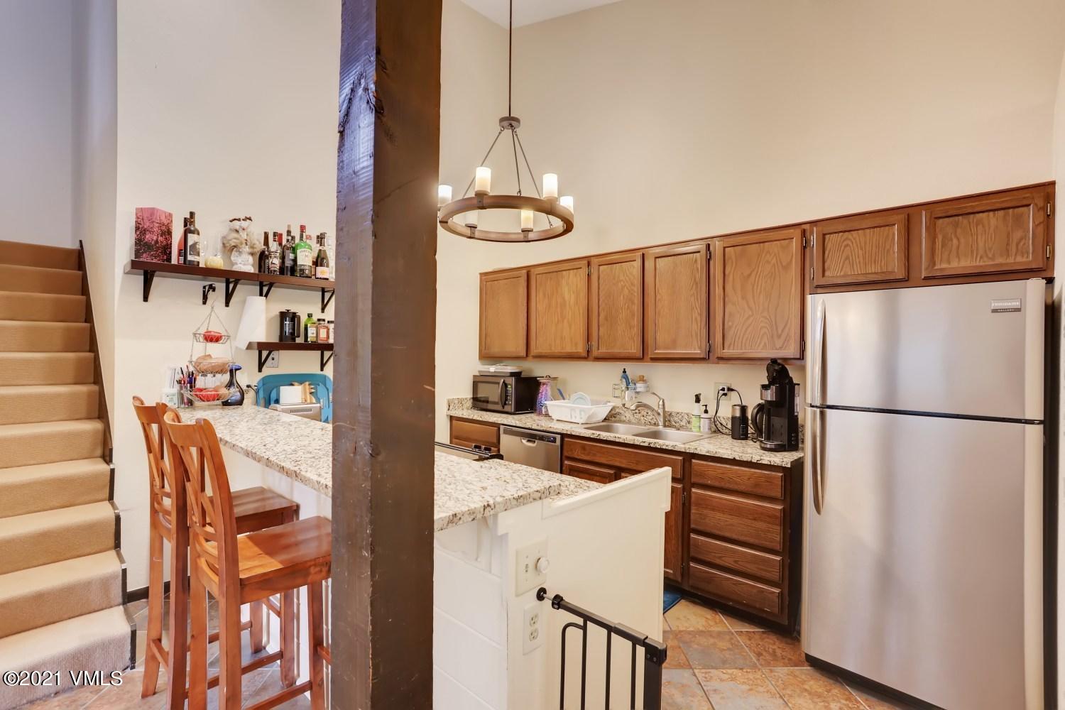 225 Gopher Road, Unit H50 Avon, CO 81620 - Photo 8 of 28 a kitchen with stainless steel appliances granite countertop a refrigerator and a stove top oven