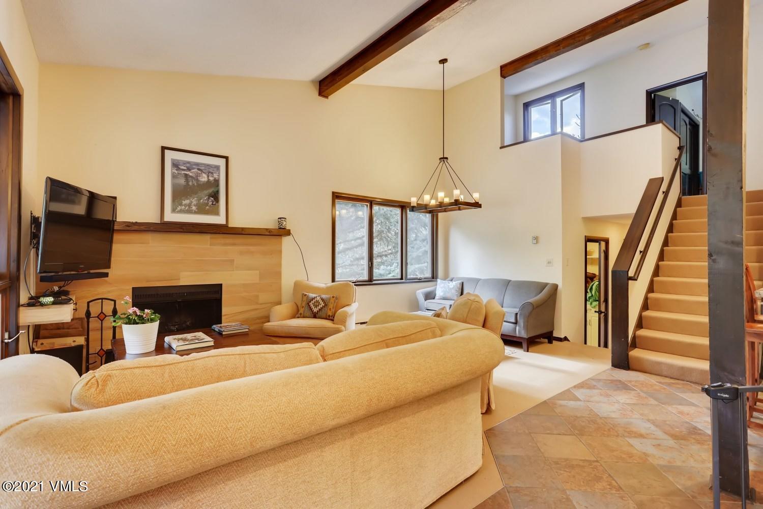 225 Gopher Road, Unit H50 Avon, CO 81620 - Photo 10 of 28 a living room with furniture a fireplace and a flat screen tv