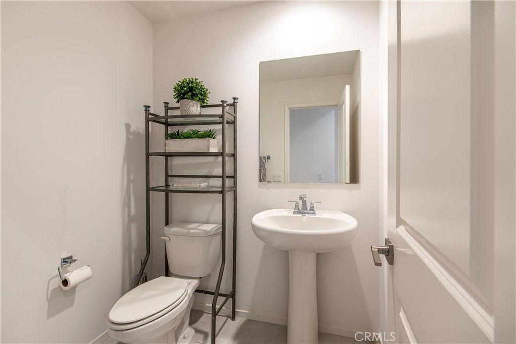 8474 Explorer Street Chino, CA 91708 - Photo 11 of 36 a bathroom with a toilet sink and mirror
