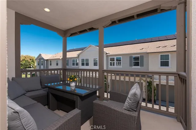 a dining room with furniture and a floor to ceiling window