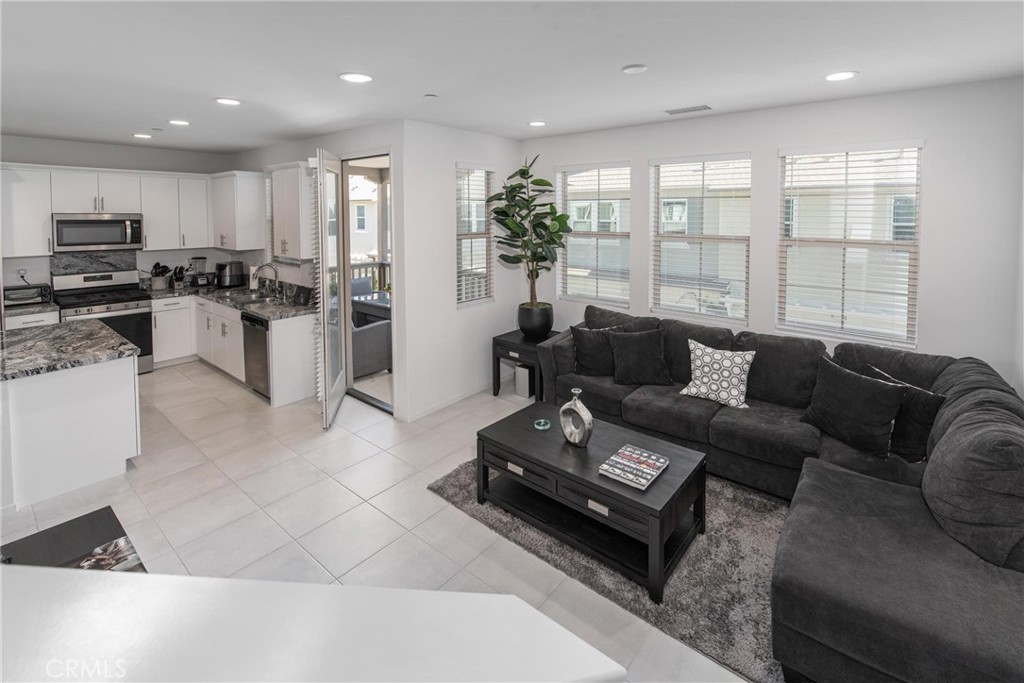 8474 Explorer Street Chino, CA 91708 - Photo 15 of 36 a living room with furniture kitchen and a large window