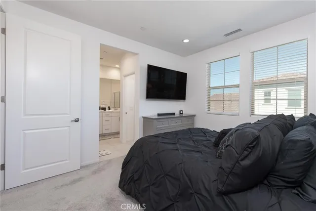 a living room with a bed furniture and a flat screen tv