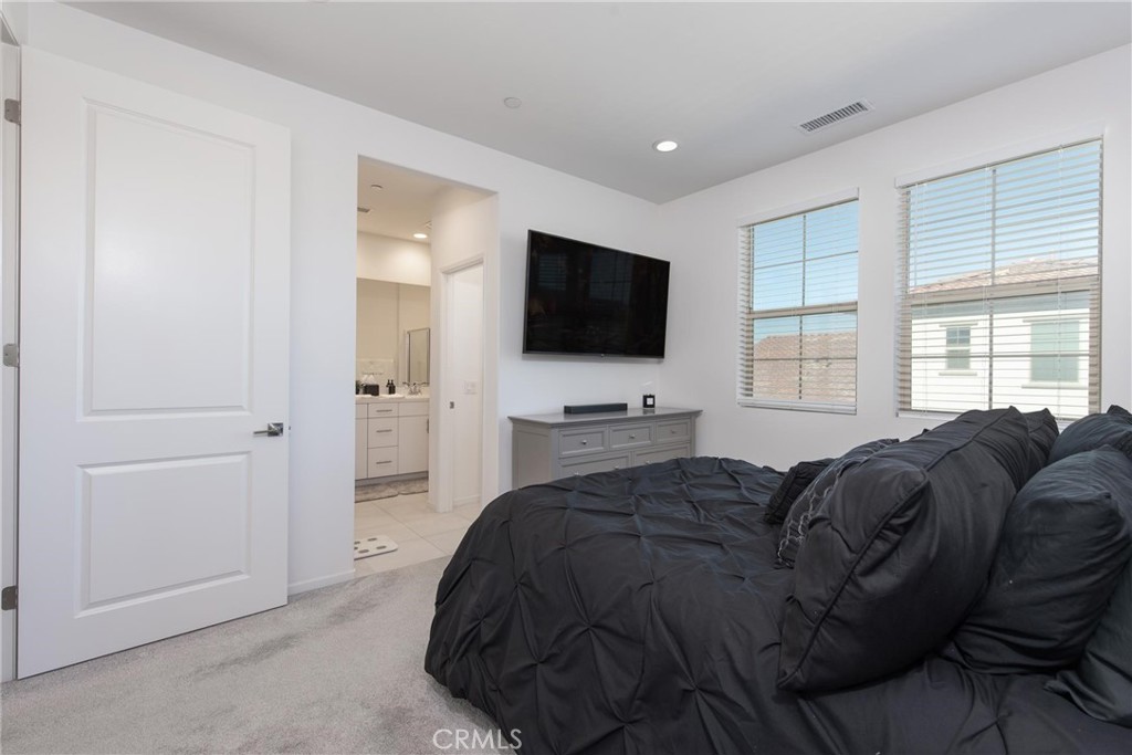 8474 Explorer Street Chino, CA 91708 - Photo 17 of 36 a living room with a bed furniture and a flat screen tv