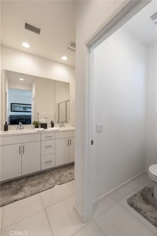 a kitchen with a sink and white cabinets
