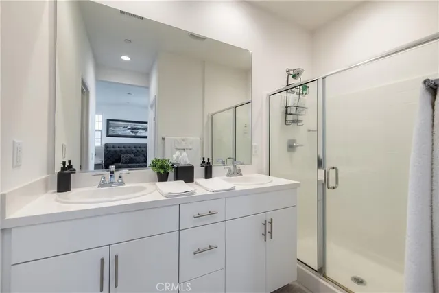 a bathroom with a double vanity sink mirror and double