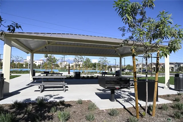a view of a patio with a table chairs and a small yard