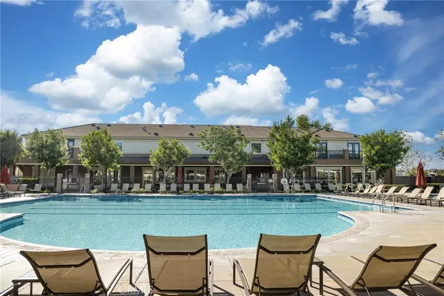 a view of a swimming pool and a back yard
