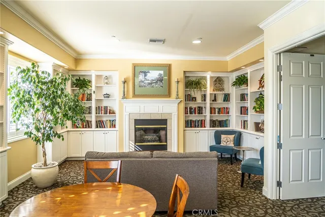 a living room with furniture fireplace and a large window