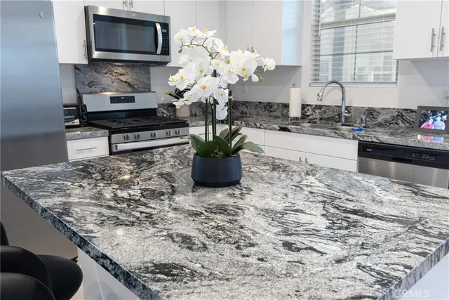 a kitchen with a stove a sink and a microwave