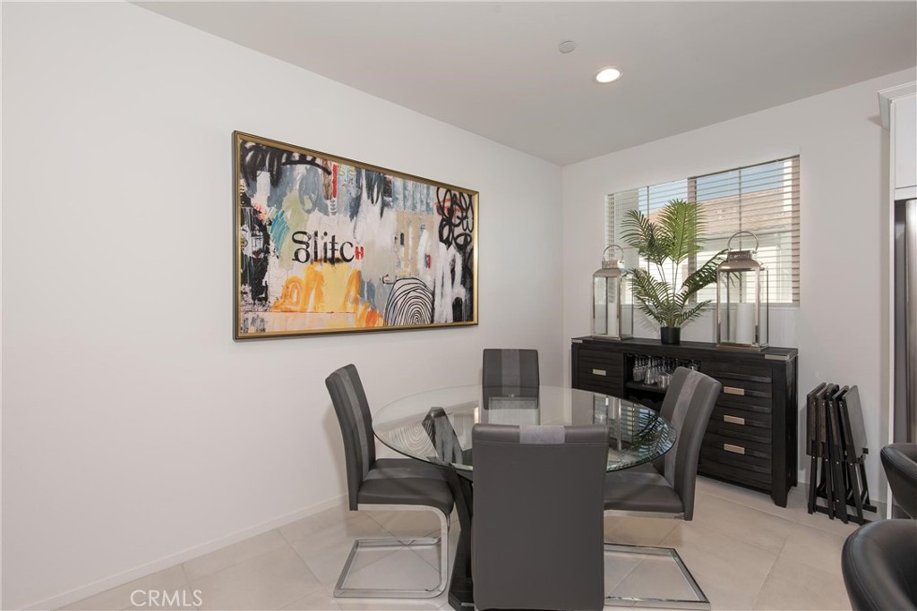 8474 Explorer Street Chino, CA 91708 - Photo 9 of 36 a view of a dining room with furniture and chandelier