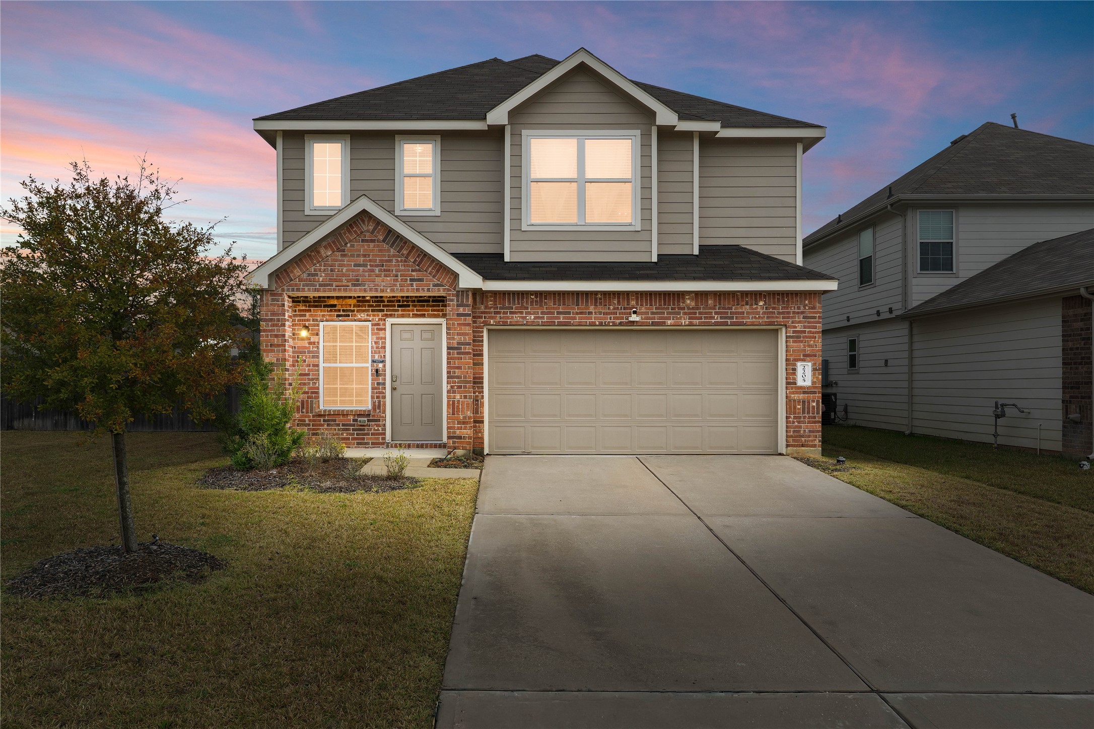 a front view of a house with a yard and garage