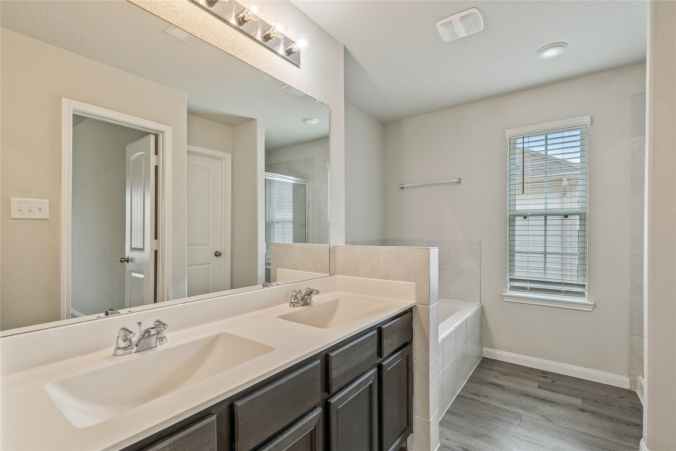 2205 Angie Kaye Drive Conroe, TX 77301 - Photo 27 of 46 a bathroom with a sink double vanity and a mirror