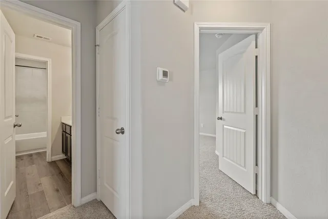 a view of a bathroom from a hallway