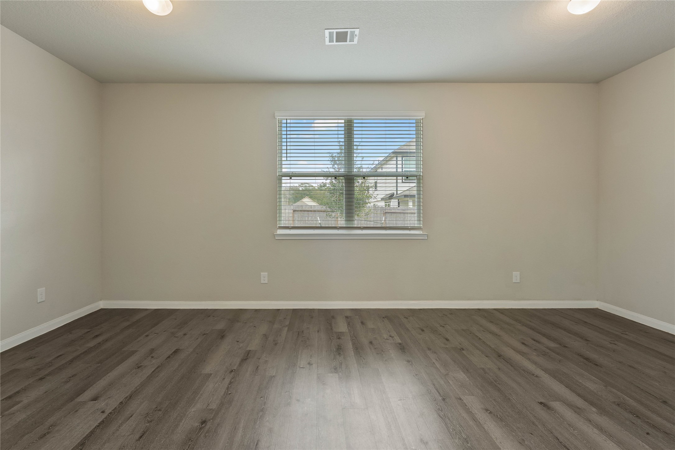 2205 Angie Kaye Drive Conroe, TX 77301 - Photo 36 of 46 an empty room with wooden floor and windows
