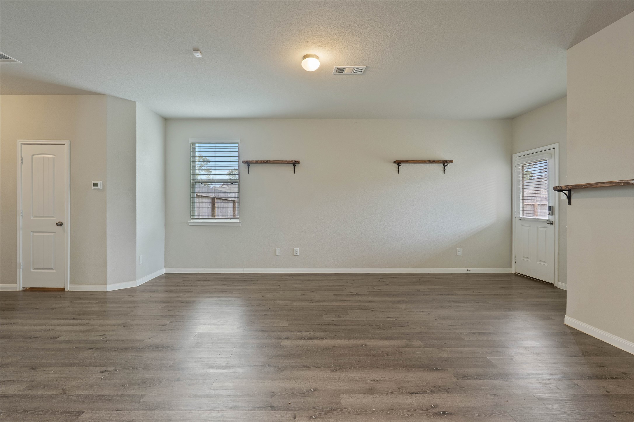 2205 Angie Kaye Drive Conroe, TX 77301 - Photo 10 of 46 an empty room with wooden floor and a window