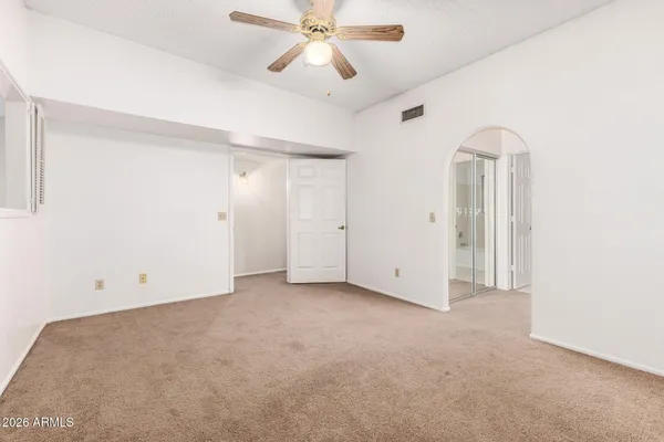 a view of empty room with ceiling fan
