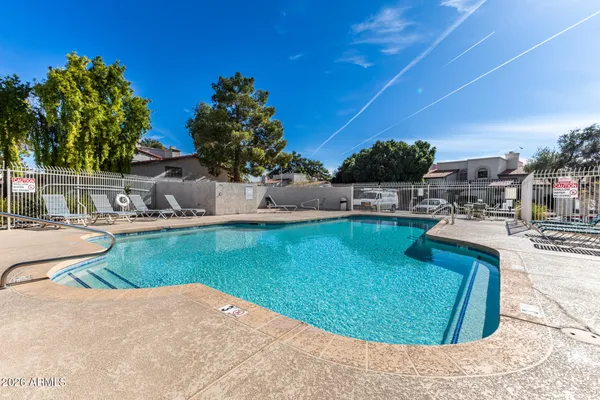 a swimming pool with outdoor seating and yard