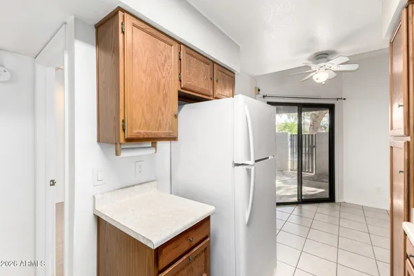a kitchen with a refrigerator a sink and cabinets