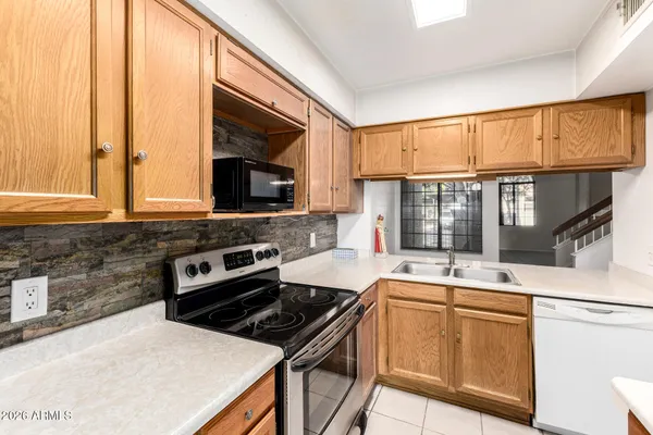 a kitchen with a stove a sink and a microwave