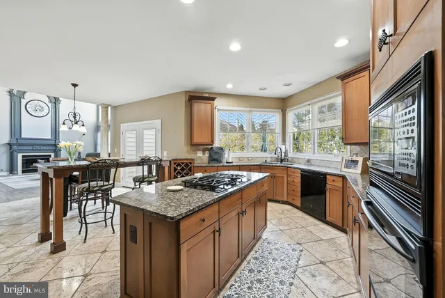 a kitchen with granite countertop a sink and a window