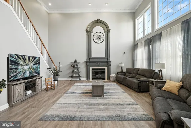 a living room with fireplace furniture and a wooden floor