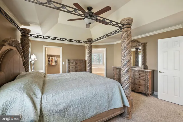 a spacious bedroom with a bed and a ceiling fan