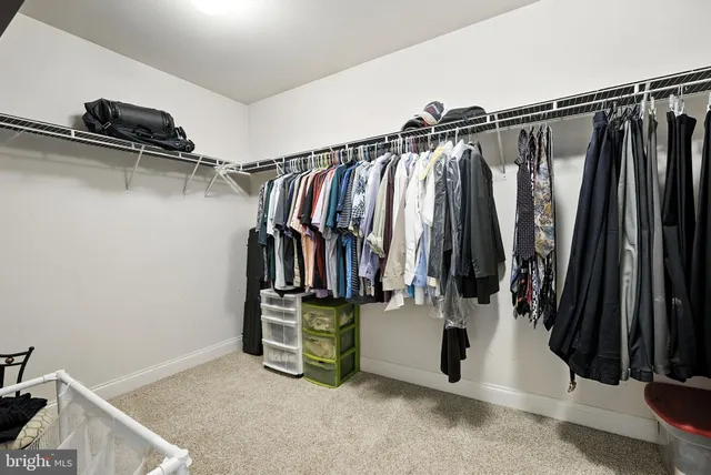 a spacious bedroom with a bed and a chandelier