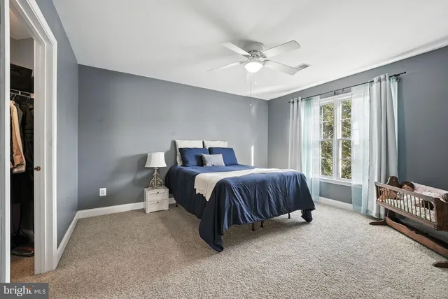 a bedroom with a bed and window