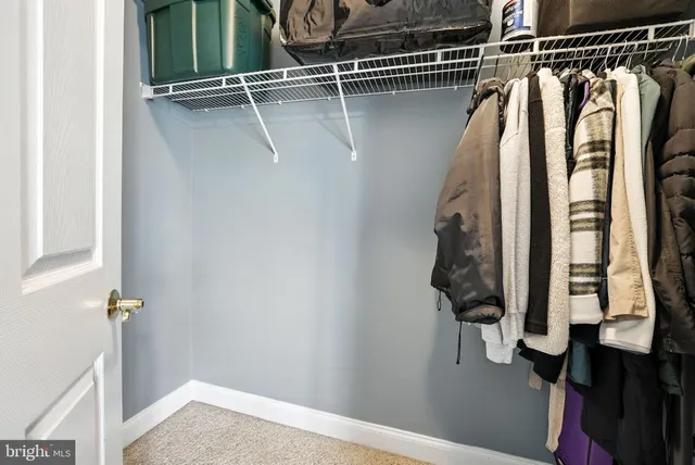 a living room with furniture a couch and kitchen view