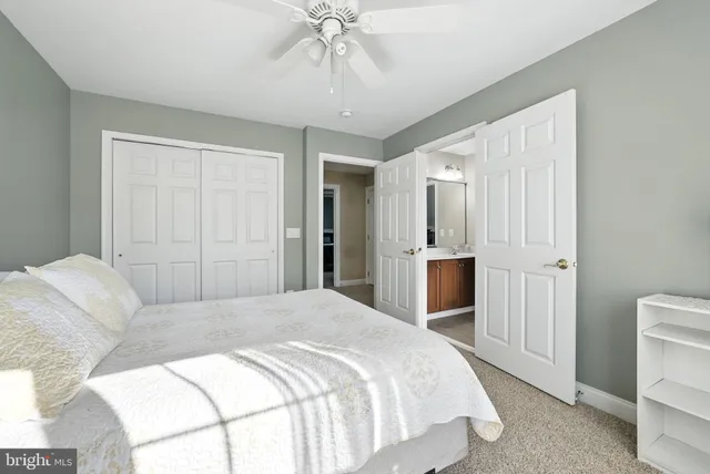 a bedroom with a bed and a desk