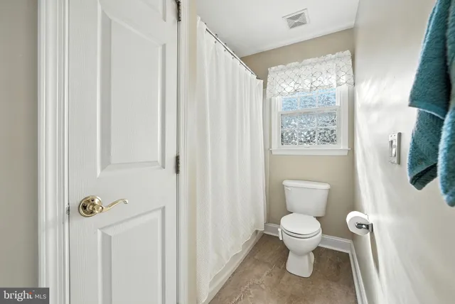 a view of a balcony with chairs and wooden floor