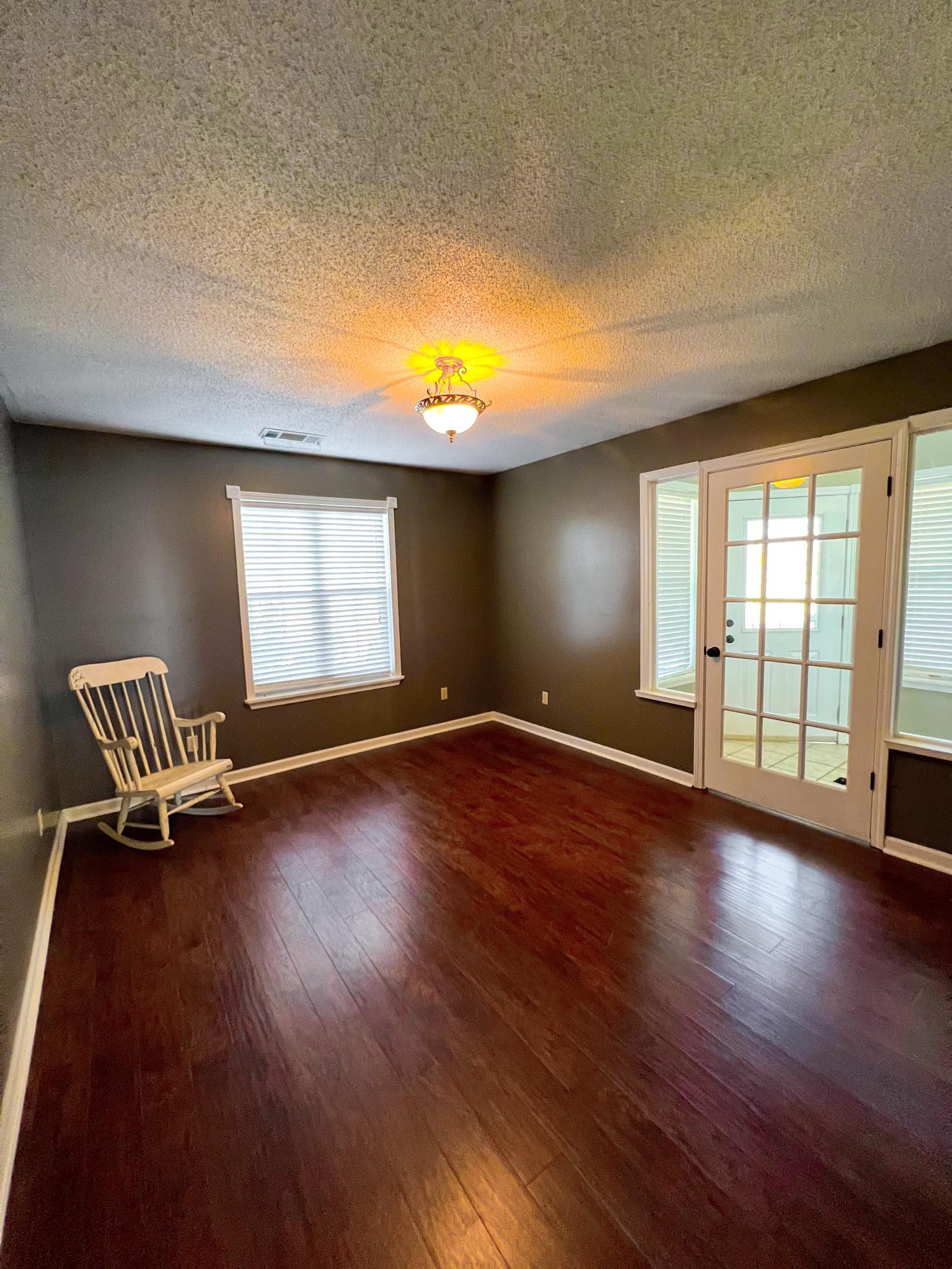 96 County Road 178 Iuka, MS 38852 - Photo 11 of 21 an empty room with wooden floor and windows
