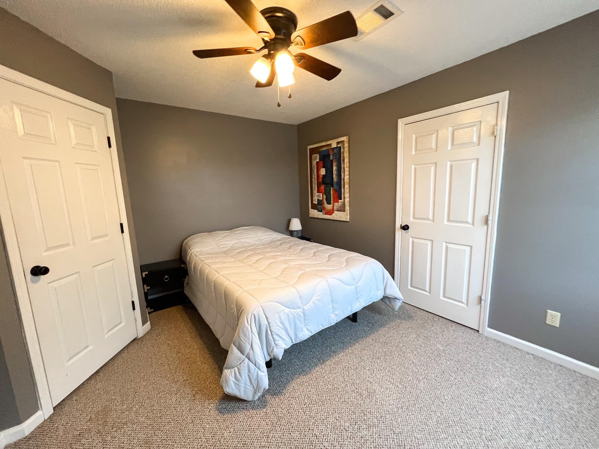 96 County Road 178 Iuka, MS 38852 - Photo 16 of 21 a spacious bedroom with a bed and a chandelier