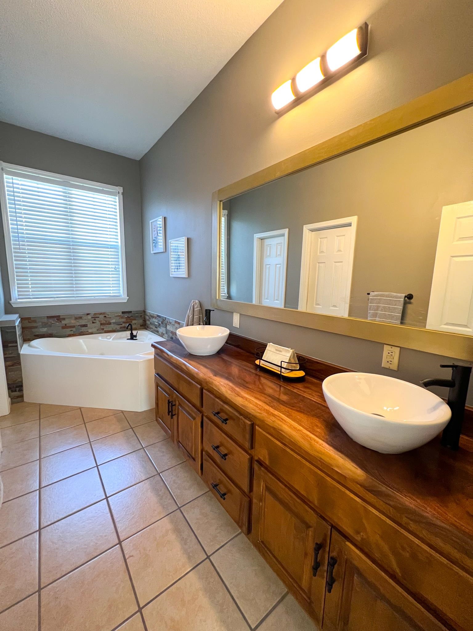 96 County Road 178 Iuka, MS 38852 - Photo 9 of 21 a spacious bathroom with a double vanity sink a mirror and a bathtub