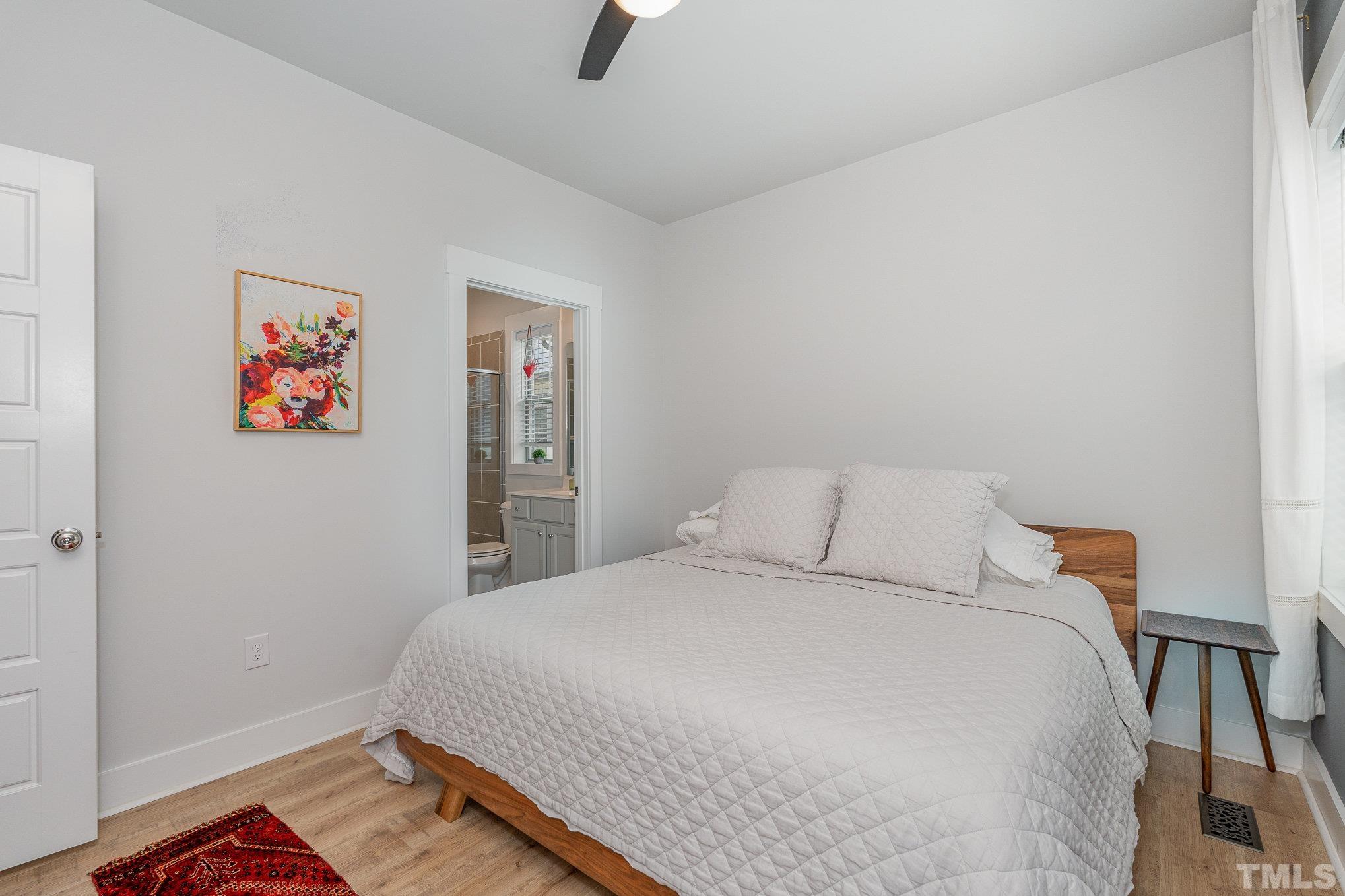 282 Cottage Way, Unit 48 Pittsboro, NC 27312 - Photo 11 of 16 a bedroom with a bed and a painting on the wall