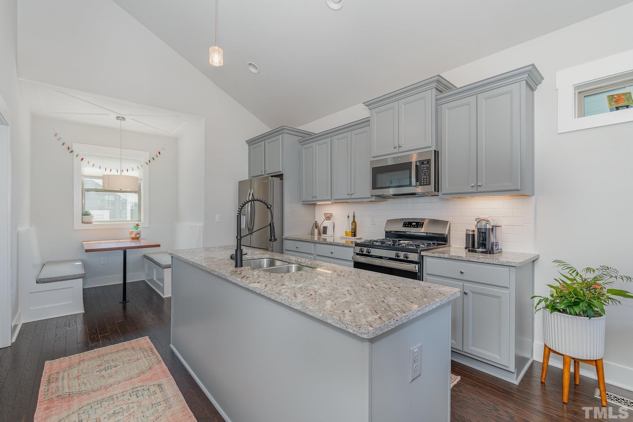 282 Cottage Way, Unit 48 Pittsboro, NC 27312 - Photo 7 of 16 a kitchen with granite countertop a sink stove and cabinets