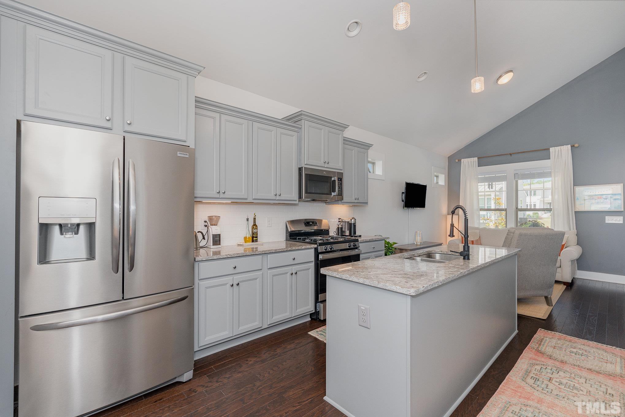 282 Cottage Way, Unit 48 Pittsboro, NC 27312 - Photo 8 of 16 a kitchen with stainless steel appliances granite countertop a refrigerator stove a sink and white cabinets