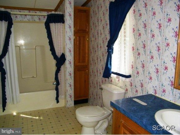 3922 Fox Hunters Road, Unit 1 Harrington, DE 19952 - Photo 12 of 16 a bathroom with a granite countertop sink toilet and shower
