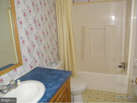 3922 Fox Hunters Road, Unit 1 Harrington, DE 19952 - Photo 13 of 16 a bathroom with a sink toilet and shower