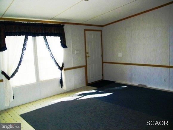 3922 Fox Hunters Road, Unit 1 Harrington, DE 19952 - Photo 5 of 16 a view of a big room with wooden floor and windows