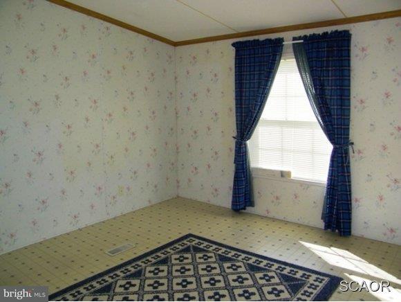 3922 Fox Hunters Road, Unit 1 Harrington, DE 19952 - Photo 8 of 16 an empty room with a window