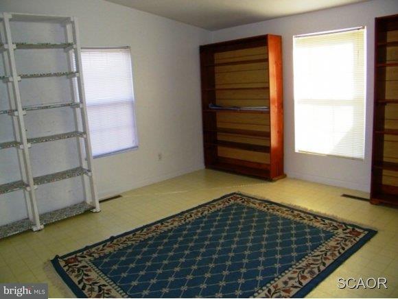 3922 Fox Hunters Road, Unit 1 Harrington, DE 19952 - Photo 10 of 16 a bedroom with a bed and a window