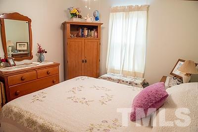 133 Hugh Blalock Road Roxboro, NC 27574 - Photo 14 of 20 a bedroom with a bed and a dresser