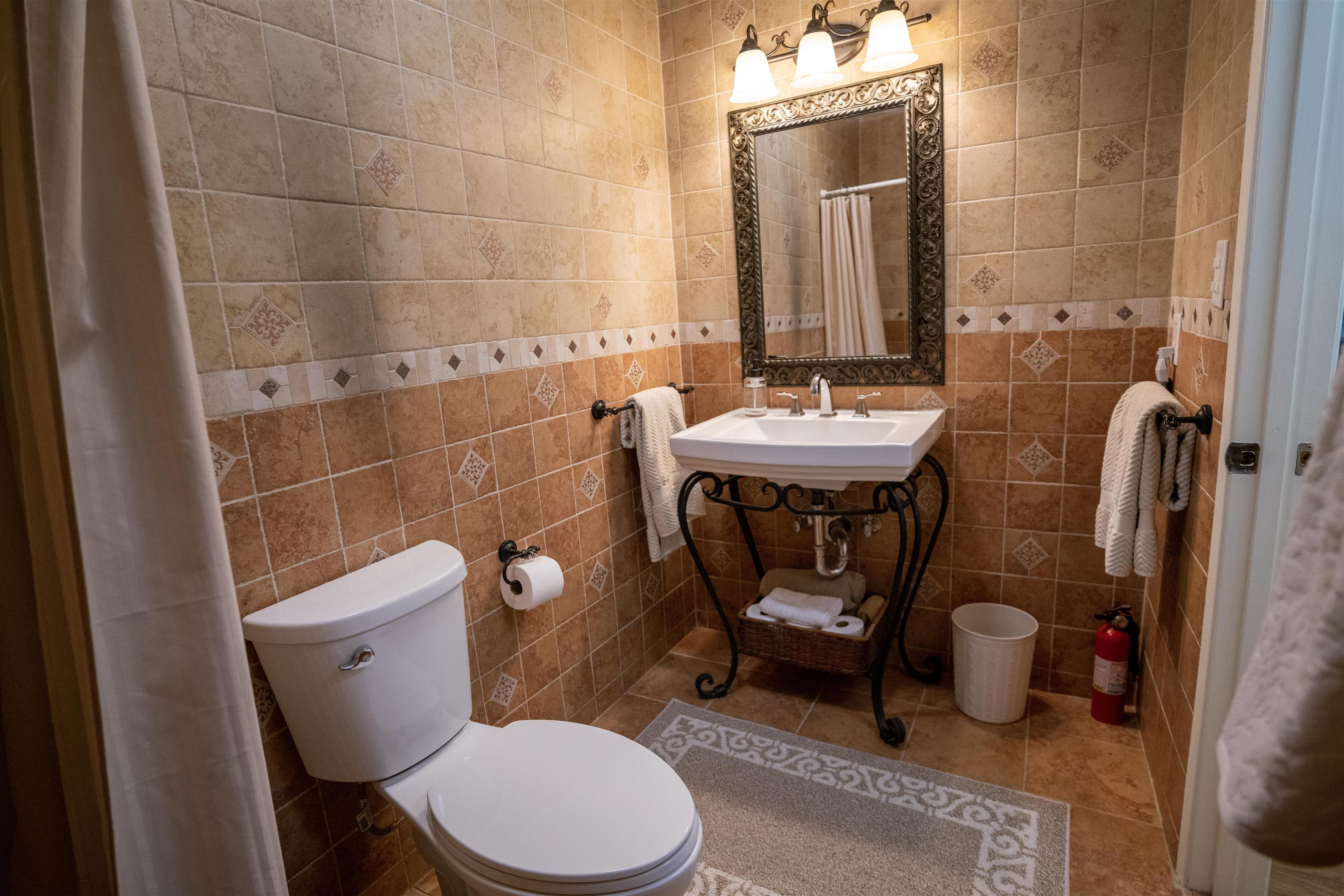 107 Mehani Place Kihei, HI 96753 - Photo 12 of 30 a bathroom with a toilet a sink and mirror