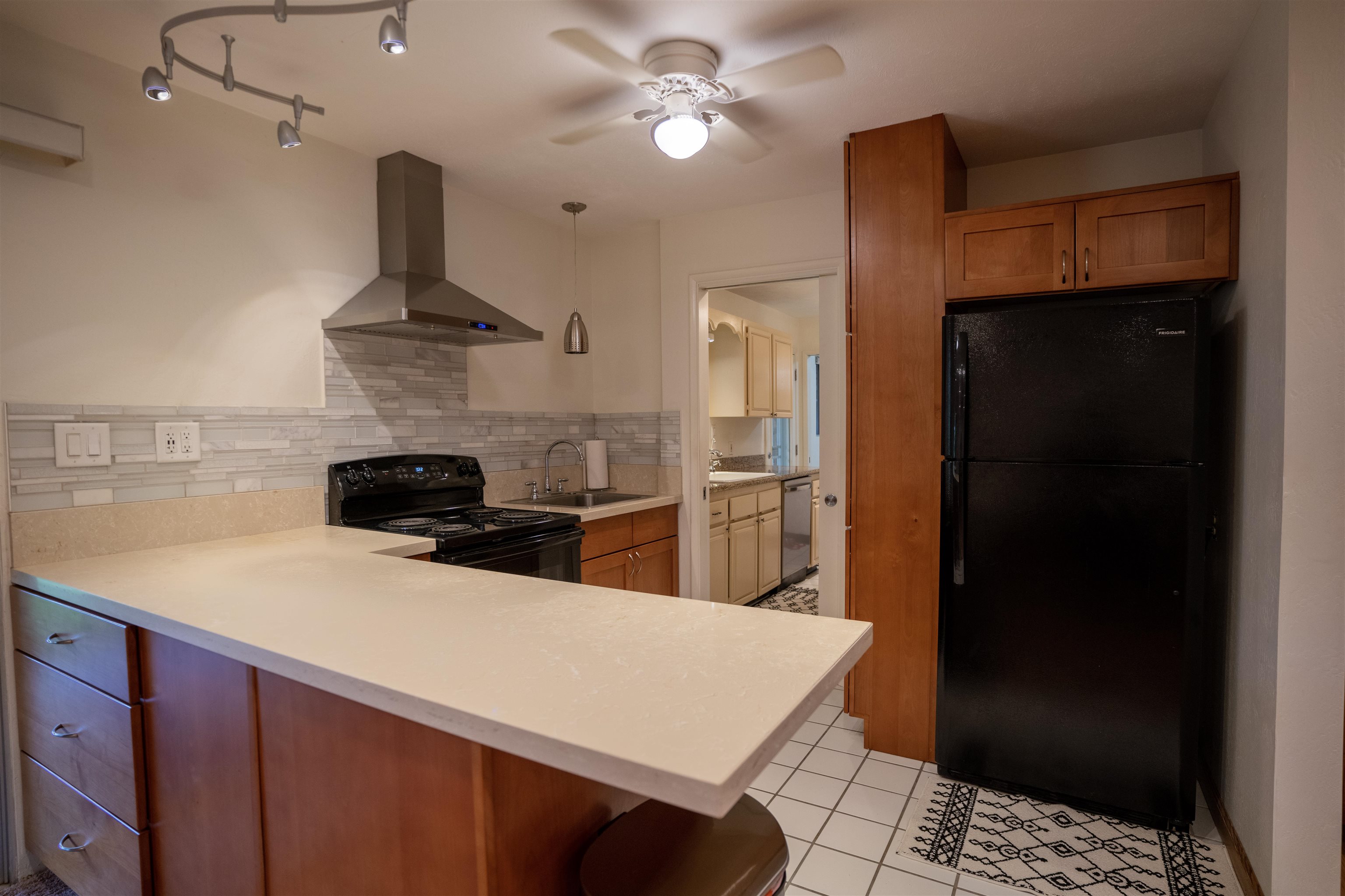 107 Mehani Place Kihei, HI 96753 - Photo 14 of 30 a kitchen with a refrigerator a stove top oven a sink and dishwasher