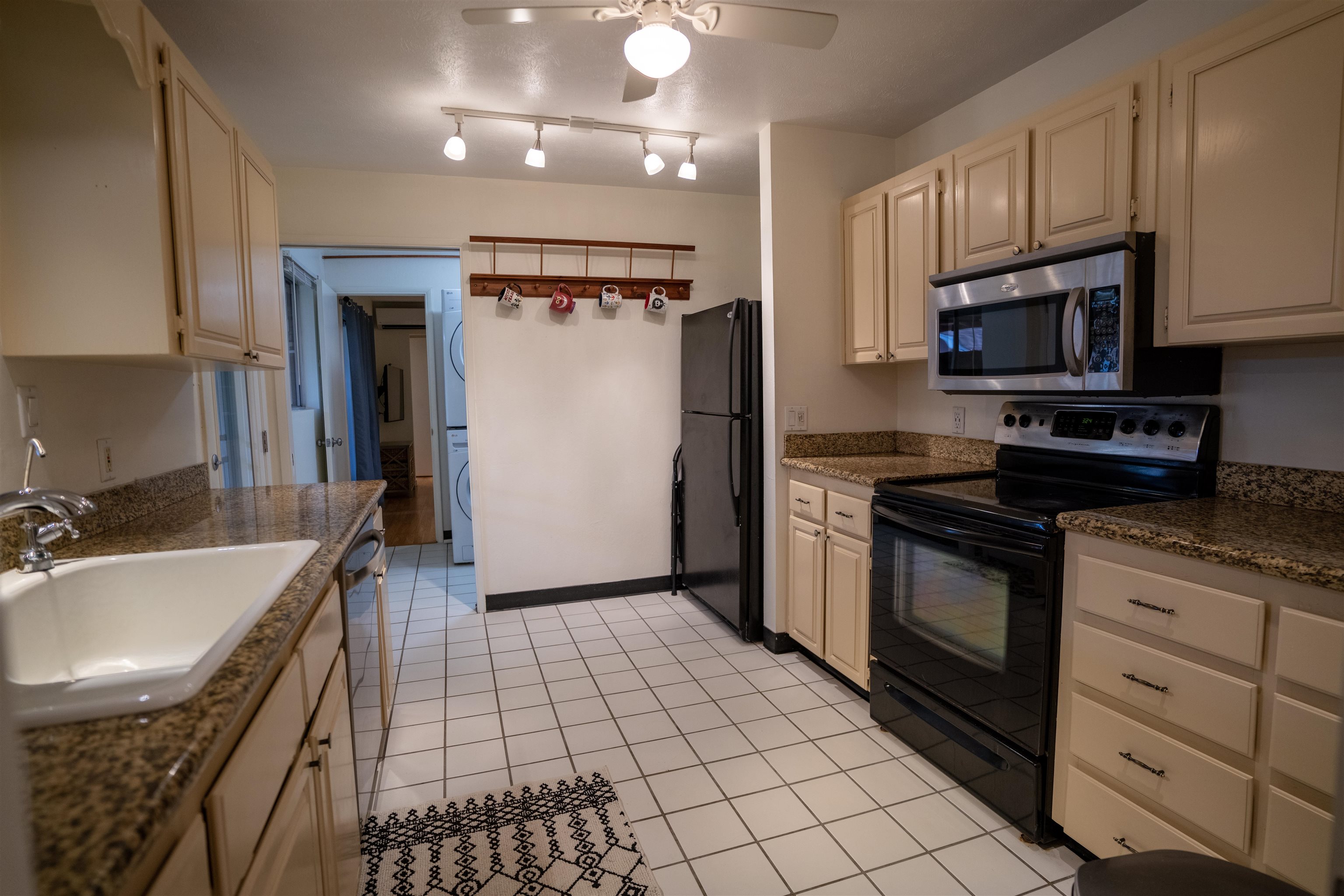 107 Mehani Place Kihei, HI 96753 - Photo 15 of 30 a kitchen with stainless steel appliances granite countertop a sink stove and refrigerator